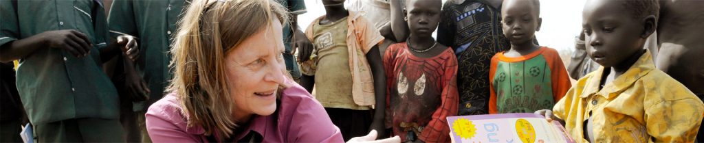 woman serving young african child through International Ministries