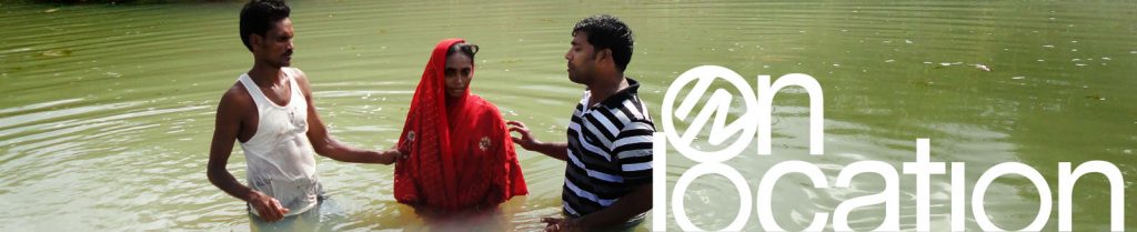 woman in India being baptized in a river
