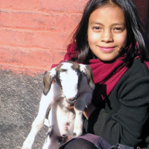 Image of girl holding a baby goat